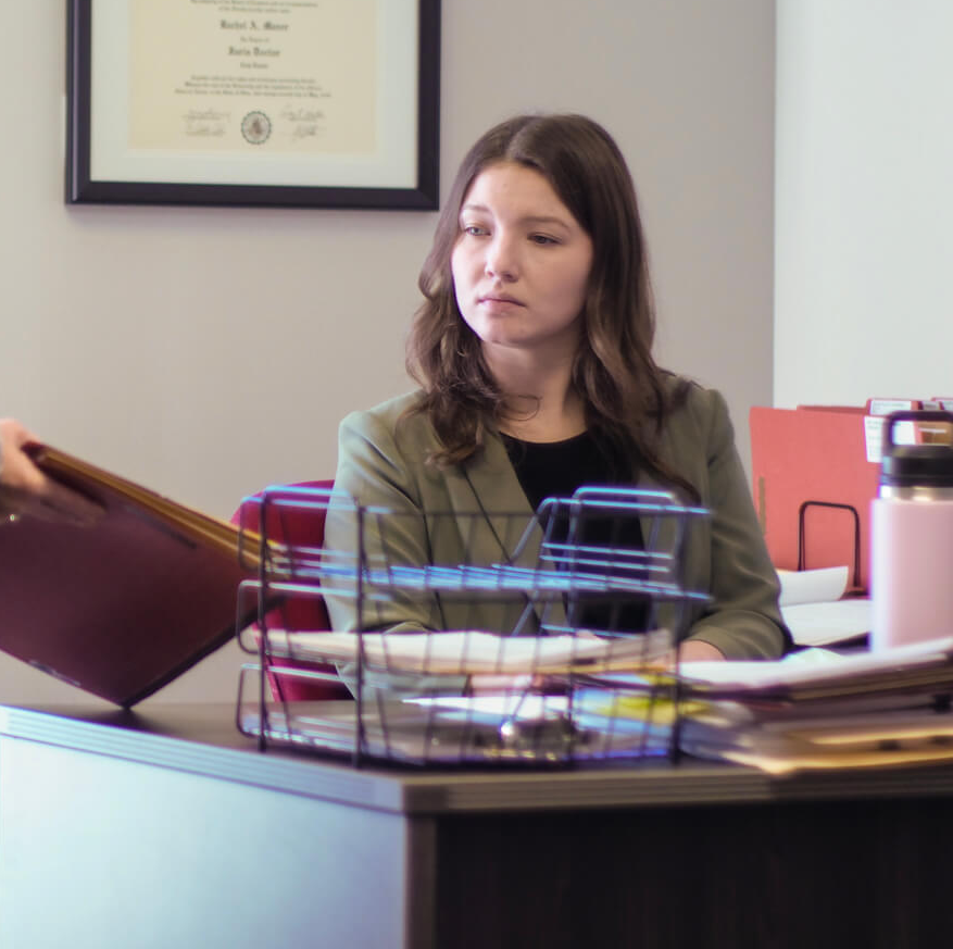 Rachel receiving documents in her office